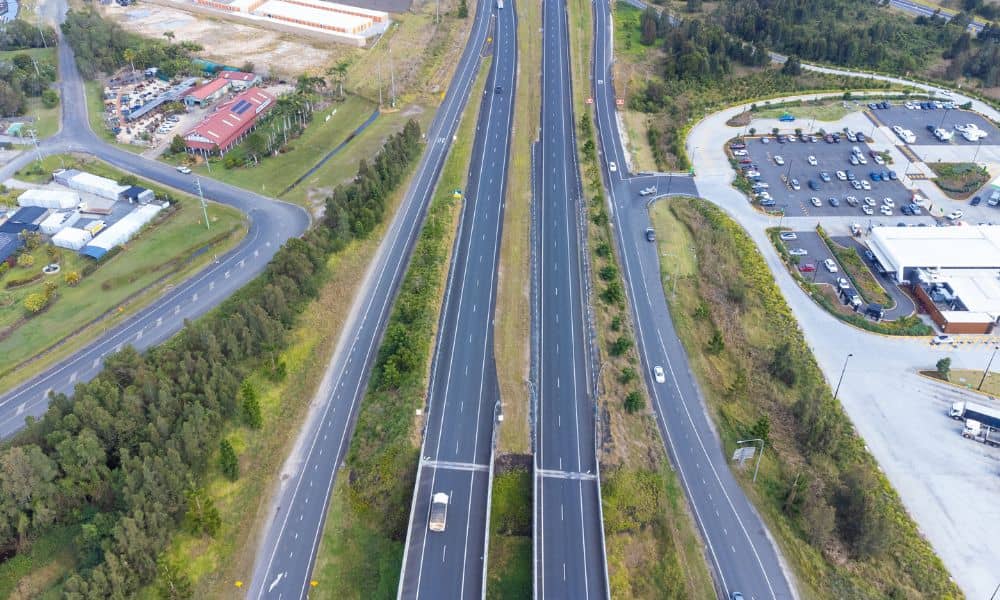 Aerial view of a modern highway corridor showing traffic flow, land development, and updated roadway design features in a growing  region