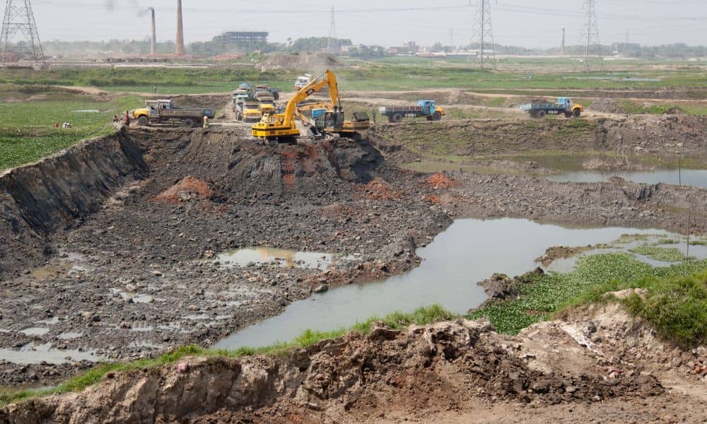 Civil engineering companies constructing a stormwater detention pond to control runoff and prevent drainage delays
