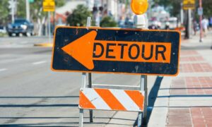 Detour sign used by a traffic engineer to redirect vehicles during a freeway shutdown