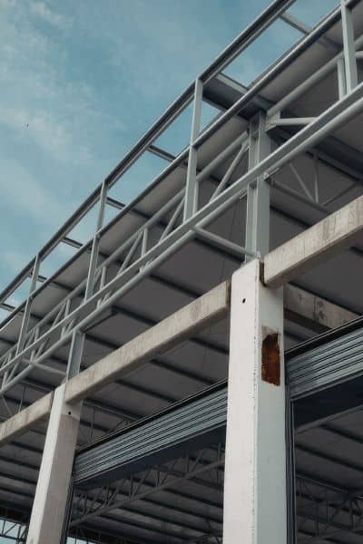 Steel frame building structure exposed - ALTA SURVEY Texas Structural engineer examining exposed steel framing and load-bearing system of commercial building