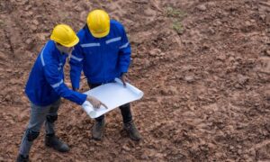 Surveyors reviewing site plans - ALTA SURVEY Texas Surveyors reviewing property plans before land surveying to check boundaries and site conditions
