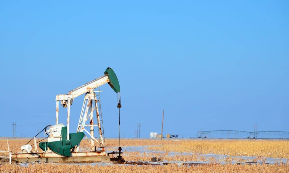 Oil pumpjack operating in Midland TX oilfield with dry field conditions, relevant to ALTA land survey assessments