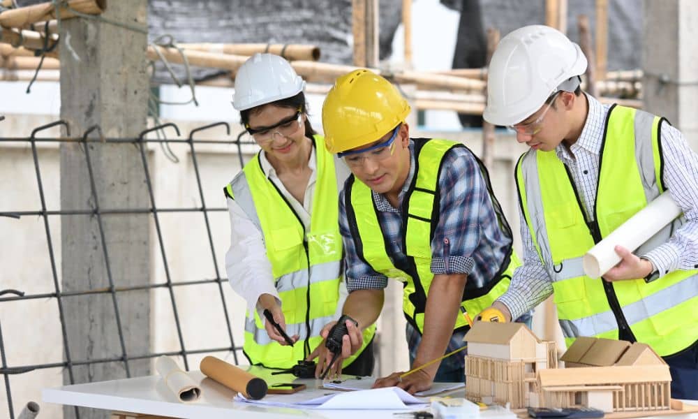 Project management denton property developers - ALTA SURVEY Texas Project management team with civil engineers reviewing construction plans on site in Denton