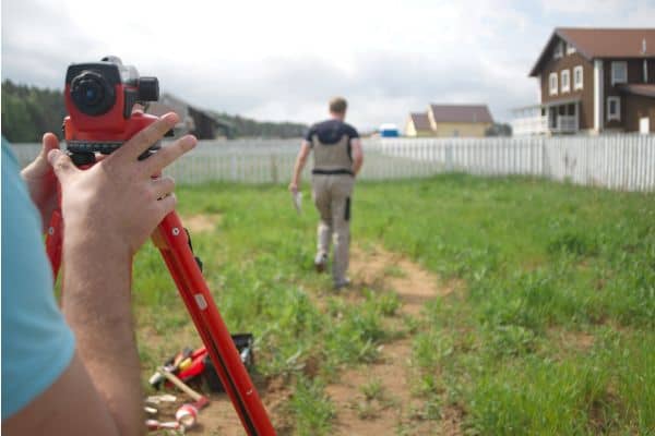 due diligence boundary survey - ALTA SURVEY Texas Licensed land surveyor conducting measurements during due diligence