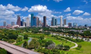 Skyline of Houston, Texas with green spaces and residential areas, highlighting the importance of accurate boundary surveys for property owners.