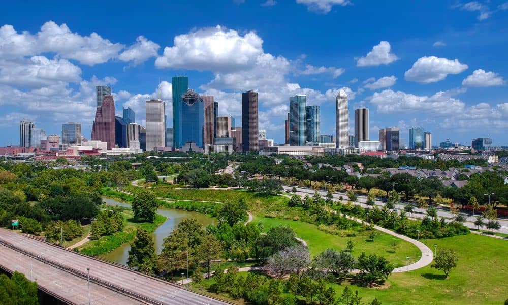 boundary survey - Skyline of Houston, Texas with green spaces and residential areas, highlighting the importance of accurate boundary surveys for property owners.