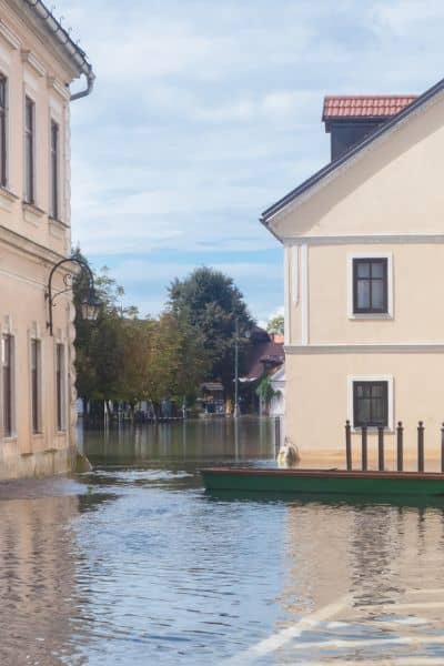 Flooded residential building showing why a flood elevation certificate is vital for homeowners
