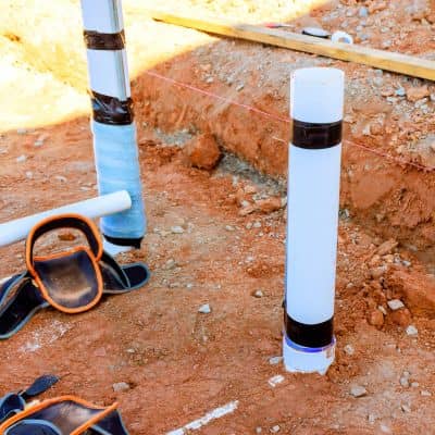 Layout stakes and string line marking utility placement during a construction survey on a building site
