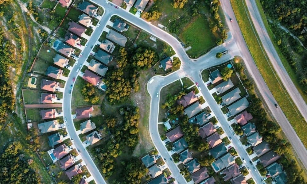 Aerial view of residential homes, streets, and property lots for a mortgage closing survey involving shared water service