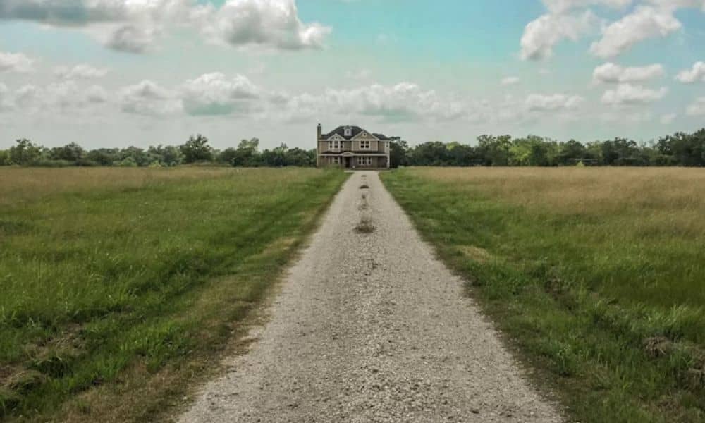 Gravel farm road crossing open acreage on property being considered for a lot survey